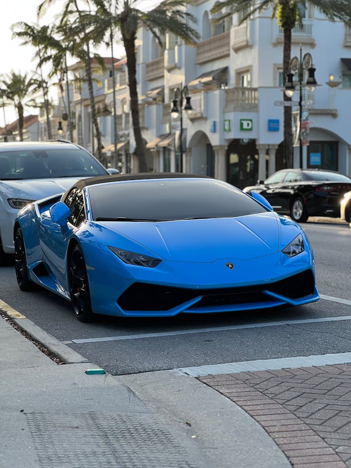 Stunning blue Lamborghini Huracan parked on a vibrant street in Florida.